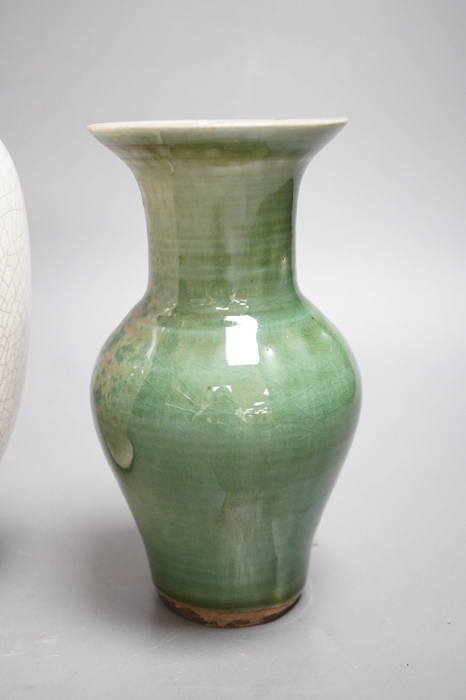 A Chinese white crackleware vase and a smaller green glazed vase